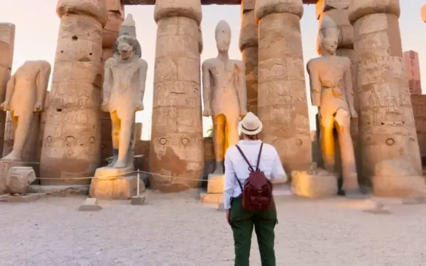 A guided visitor among the columns of Luxor Temple