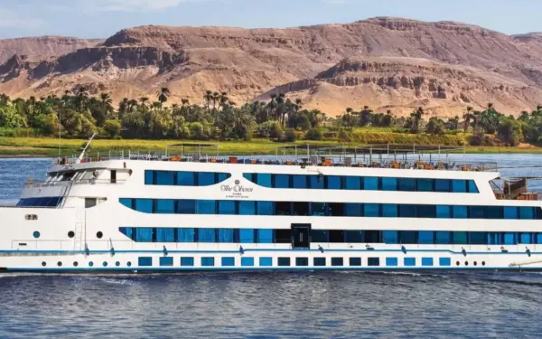 A Nile cruise vessel sailing between Luxor and Aswan at golden hour